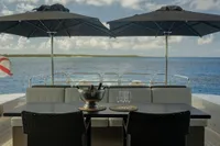 Luxury yacht deck with seating, umbrellas, and ocean view; Arno Leopard 31 OPEN, 2006 model.