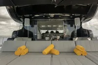 Luxury yacht Arno Leopard 31 OPEN 2006 with sunbathing area and yellow towels.