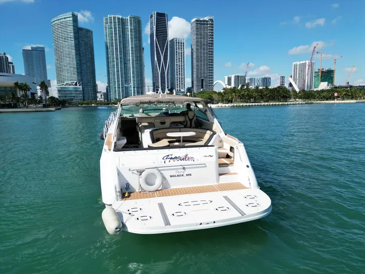  Yacht Photos Pics 1998 Sea Ray 500 Sundancer yacht in urban waterfront setting with skyscrapers.