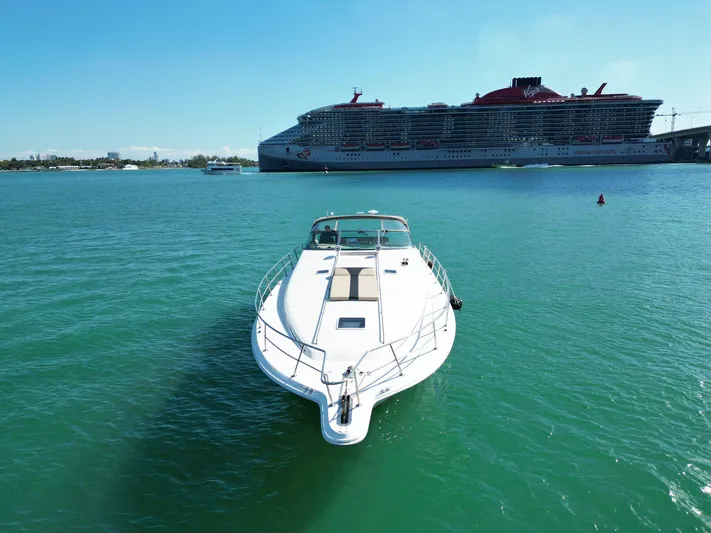  Yacht Photos Pics 1998 Sea Ray 500 Sundancer yacht on turquoise water, with a large cruise ship in the background.