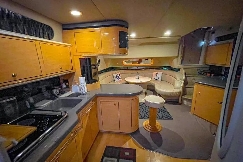  Yacht Photos Pics Interior of 1998 Sea Ray 500 Sundancer yacht with kitchen and dining area.
