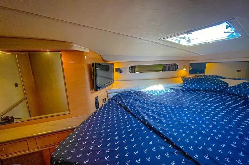  Yacht Photos Pics Luxurious cabin interior of 1998 Sea Ray 500 Sundancer yacht with nautical bedding.