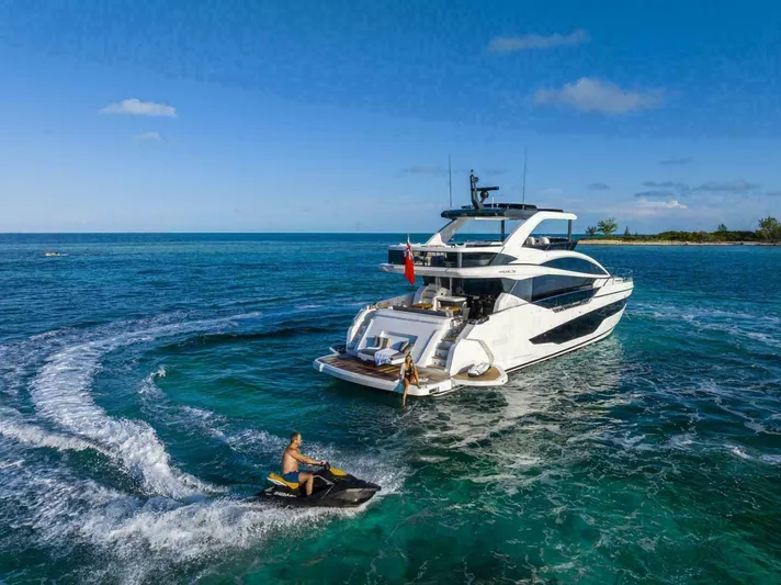 Pearl 72 Indulgence Yacht Photos Pics Luxury Pearl 72 yacht cruising with jet ski in tropical waters, 2025 model.