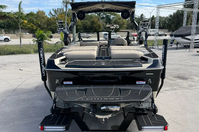  Yacht Photos Pics 2026 Centurion Ri230 boat with sleek design and luxurious seating, parked outdoors.