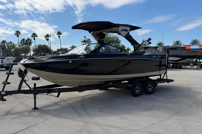  Yacht Photos Pics 2026 Centurion Ri230 boat on trailer, parked outdoors under a clear sky.