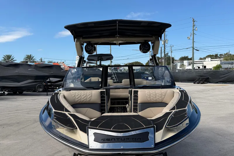  Yacht Photos Pics 2026 Centurion Ri230 boat with sleek design and luxurious seating, displayed outdoors.