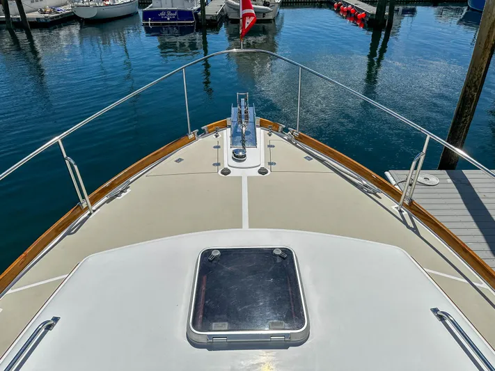 On-rush Yacht Photos Pics Bow view of 2000 Grand Banks Eastbay 43 Ex yacht docked in marina.