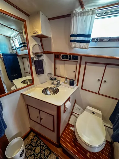 On-rush Yacht Photos Pics Bathroom interior of 2000 Grand Banks Eastbay 43 Ex yacht with sink, toilet, and mirror.