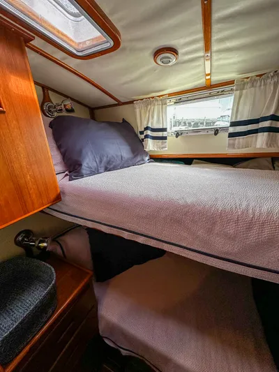 On-rush Yacht Photos Pics Cozy cabin interior of 2000 Grand Banks Eastbay 43 Ex with bed and window.
