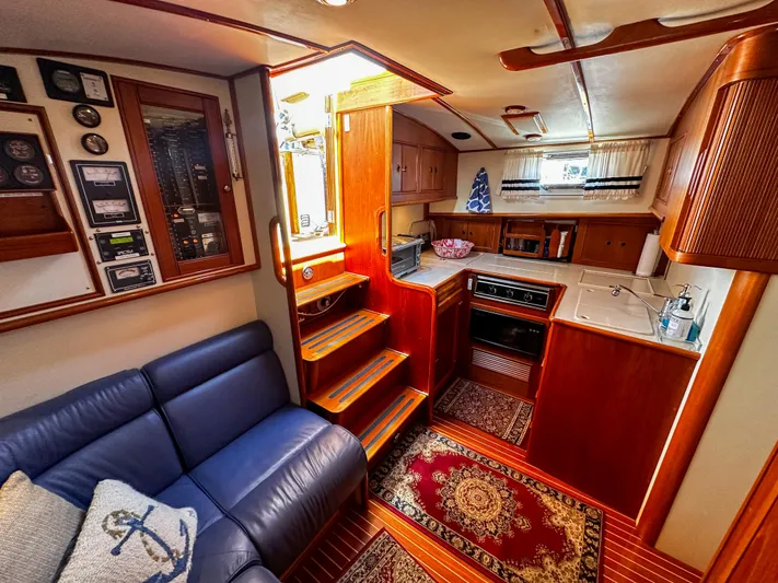On-rush Yacht Photos Pics Interior of 2000 Grand Banks Eastbay 43 Ex yacht with kitchen and seating area.