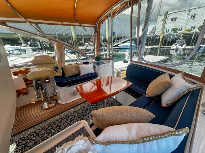 On-rush Yacht Photos Pics Luxurious interior of 2000 Grand Banks Eastbay 43 Ex yacht with plush seating and wooden table.