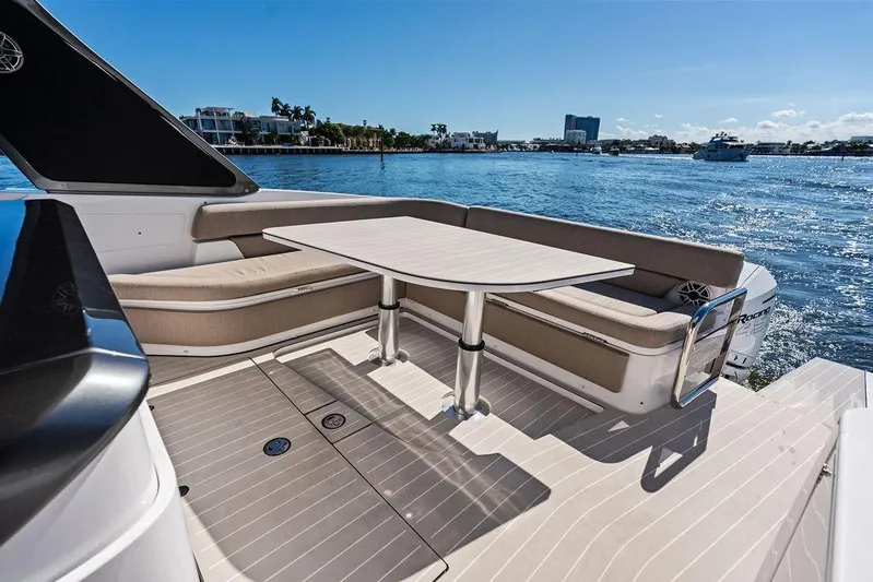  Yacht Photos Pics 2024 Azimut Verve 42 yacht deck with seating and table, overlooking serene waters.