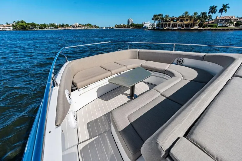  Yacht Photos Pics 2024 Azimut Verve 42 yacht with luxurious seating, cruising on a scenic waterfront.