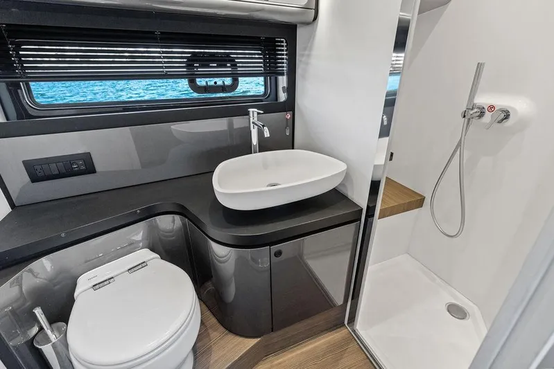  Yacht Photos Pics Luxurious bathroom in 2024 Azimut Verve 42 yacht with modern fixtures and ocean view.