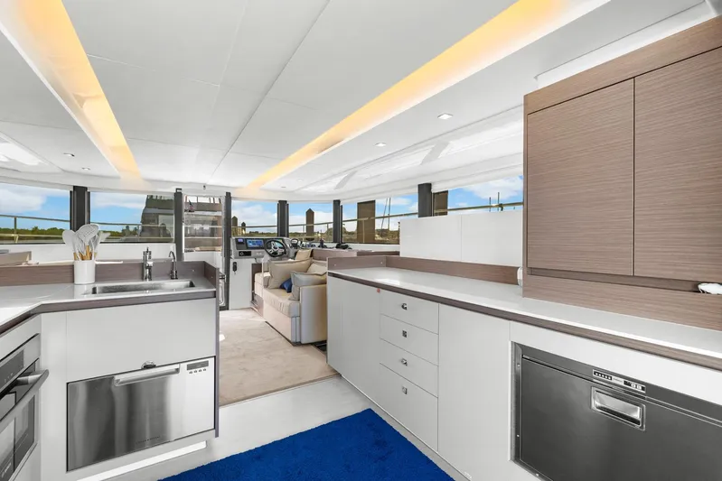Prelude Yacht Photos Pics Luxurious interior of 2024 Leopard 46 Powercat yacht with modern kitchen and helm station.