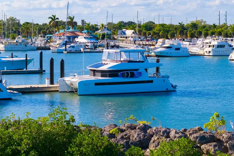 Prelude Yacht Photos Pics 2024 Leopard 46 Powercat yacht docked in a vibrant marina setting.