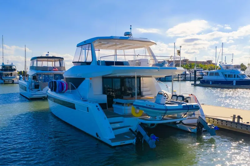 Prelude Yacht Photos Pics 2024 Leopard 46 Powercat yacht docked at marina under clear blue sky.