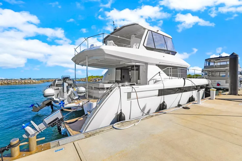 Prelude Yacht Photos Pics 2024 Leopard 46 Powercat yacht docked at marina under clear blue sky.