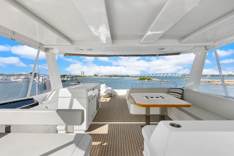 Prelude Yacht Photos Pics 2024 Leopard 46 Powercat yacht interior with seating area and ocean view.