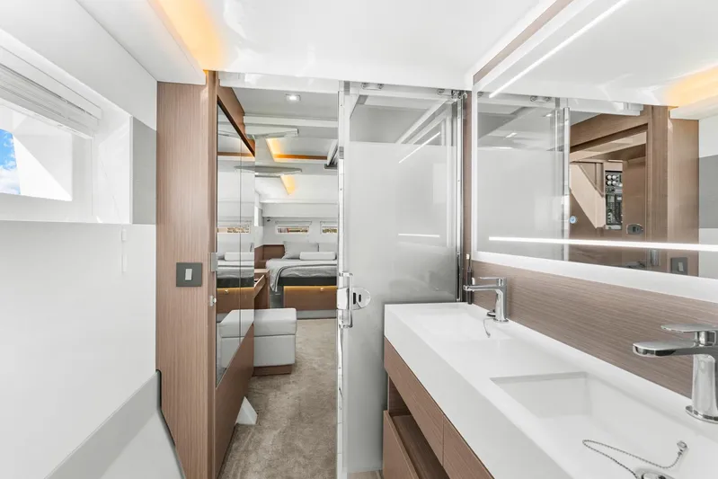 Prelude Yacht Photos Pics Luxurious interior of 2024 Leopard 46 Powercat yacht featuring modern bathroom and bedroom.