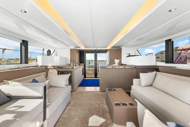 Prelude Yacht Photos Pics Luxurious interior of 2024 Leopard 46 Powercat yacht with modern furnishings and panoramic windows.