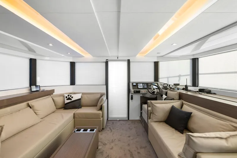 Prelude Yacht Photos Pics Luxurious interior of 2024 Leopard 46 Powercat yacht with modern seating and helm station.