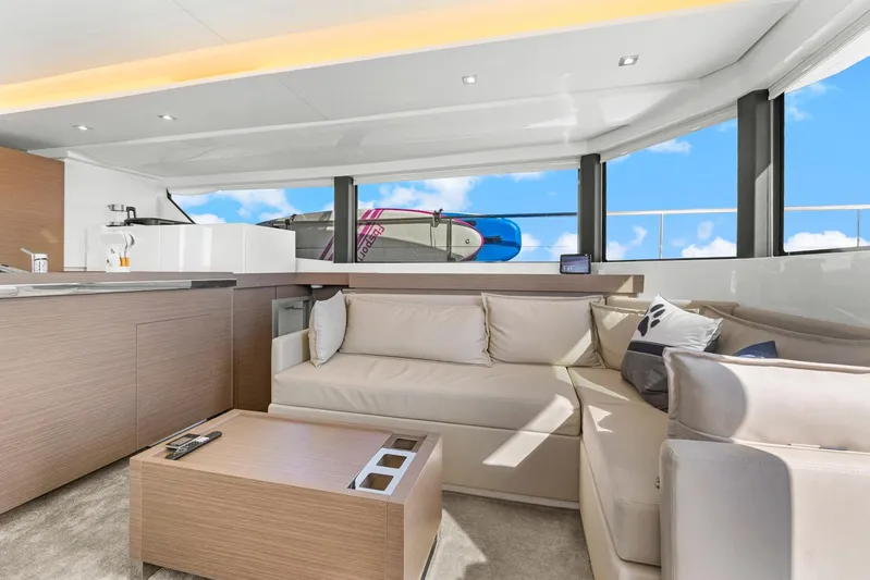 Prelude Yacht Photos Pics Luxurious interior of 2024 Leopard 46 Powercat yacht with modern seating and panoramic windows.