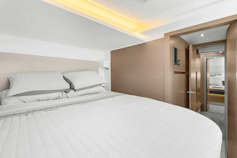 Prelude Yacht Photos Pics Luxurious bedroom interior of 2024 Leopard 46 Powercat yacht, featuring modern design and cozy bedding.