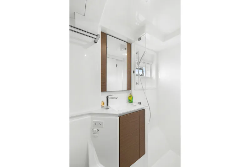 Prelude Yacht Photos Pics Modern bathroom in 2024 Leopard 46 Powercat yacht with sleek fixtures and wood accents.