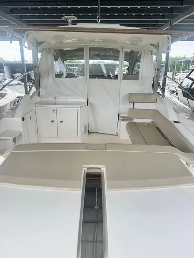  Yacht Photos Pics 2016 Pursuit SC 365i Sport Coupe interior with seating and storage under a covered dock.