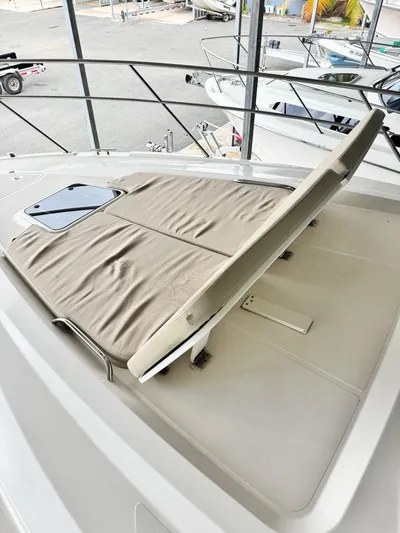  Yacht Photos Pics 2016 Pursuit SC 365i Sport Coupe with sunpad on deck, docked in marina.