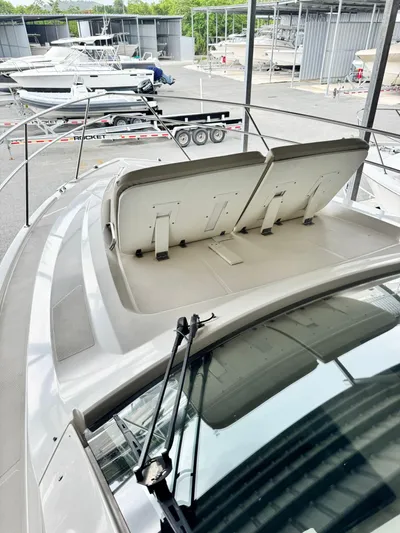  Yacht Photos Pics 2016 Pursuit SC 365i Sport Coupe boat with adjustable seating, docked in a marina.