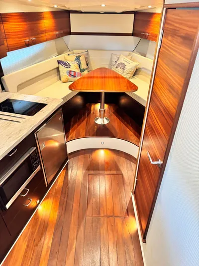  Yacht Photos Pics Luxurious interior of 2016 Pursuit SC 365i Sport Coupe with wood finishes and modern amenities.
