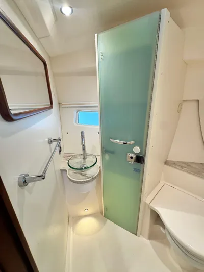  Yacht Photos Pics 2016 Pursuit SC 365i Sport Coupe bathroom with modern fixtures and frosted glass door.