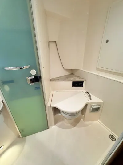  Yacht Photos Pics 2016 Pursuit SC 365i Sport Coupe bathroom with modern fixtures and compact design.