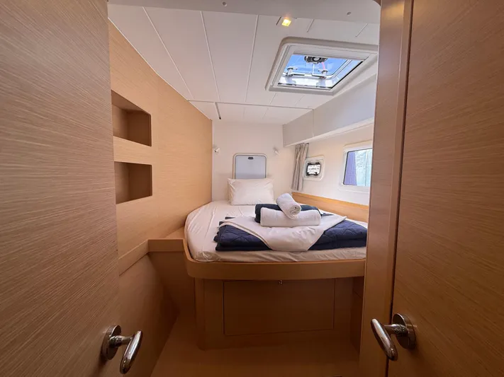 La Mer Yacht Photos Pics Cozy cabin interior of 2020 Lagoon 42 catamaran with bed and skylight.