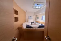 Cozy cabin interior of 2020 Lagoon 42 catamaran with bed and skylight.