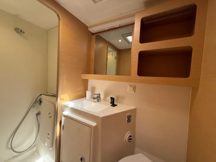 La Mer Yacht Photos Pics Modern bathroom in 2020 Lagoon 42 yacht with shower, sink, and wooden shelving.