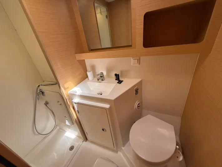 La Mer Yacht Photos Pics Modern bathroom in a 2020 Lagoon 42 yacht, featuring a shower, sink, and toilet.