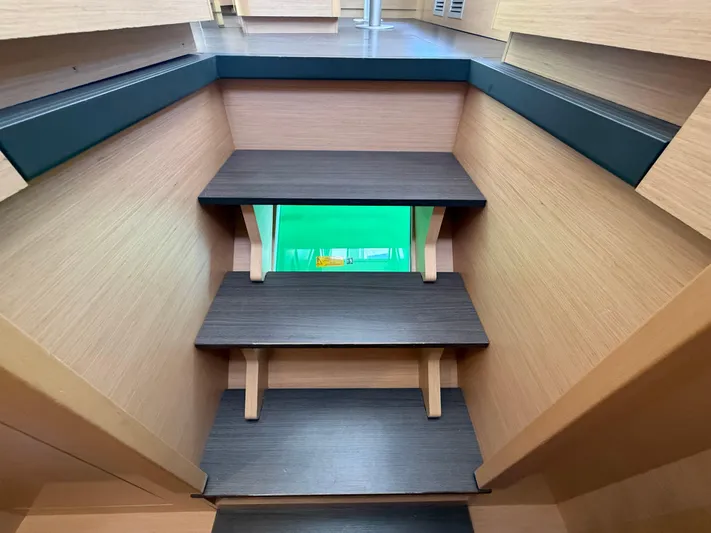 La Mer Yacht Photos Pics Interior stairs of a 2020 Lagoon 42 catamaran with modern wooden design.