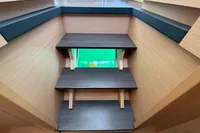 Interior stairs of a 2020 Lagoon 42 catamaran with modern wooden design.