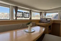 Interior of 2020 Lagoon 42 catamaran with dining area and navigation station.