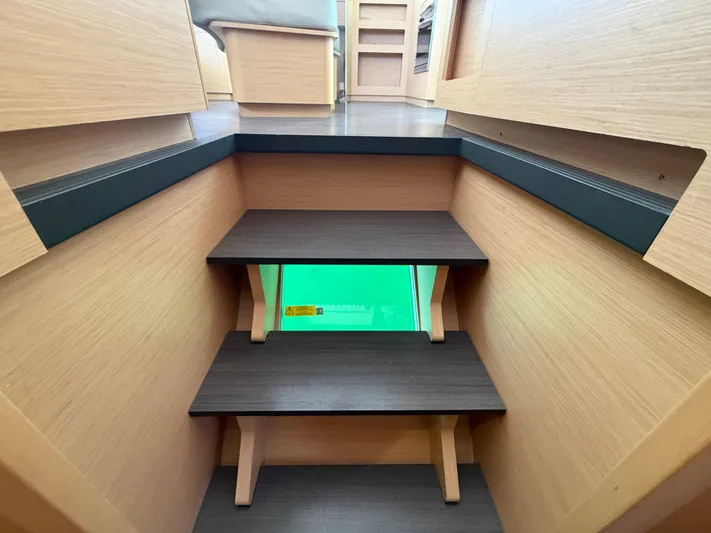 La Mer Yacht Photos Pics Interior stairs of a 2020 Lagoon 42 catamaran, featuring wooden steps and modern design.