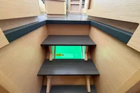 Interior stairs of a 2020 Lagoon 42 catamaran, featuring wooden steps and modern design.