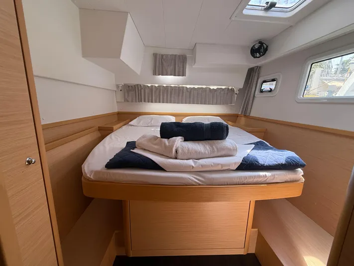 La Mer Yacht Photos Pics Cozy cabin interior of 2020 Lagoon 42 catamaran with neatly arranged bedding.