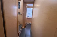 Interior hallway of 2020 Lagoon 42 yacht with wooden paneling and modern design.