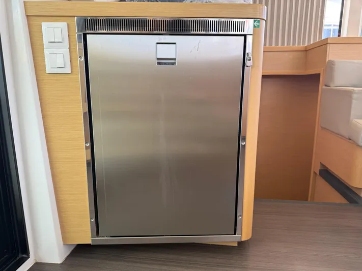 La Mer Yacht Photos Pics Stainless steel fridge on Lagoon 42 yacht, 2020 model, with wooden cabinetry.