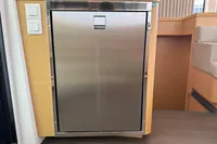 Stainless steel fridge on Lagoon 42 yacht, 2020 model, with wooden cabinetry.