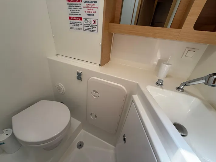 La Mer Yacht Photos Pics Bathroom interior of 2020 Lagoon 42 catamaran with toilet and sink.