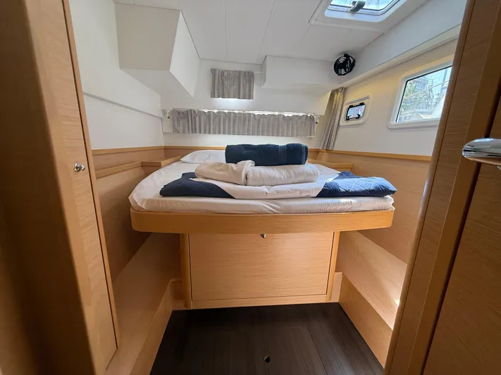 La Mer Yacht Photos Pics Cozy cabin interior of 2020 Lagoon 42 catamaran with neatly arranged bedding.